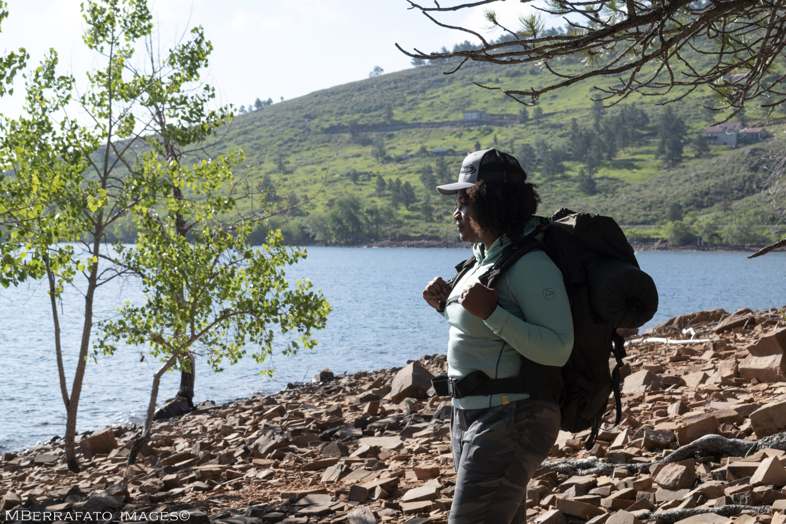 Black woman Antoinette Lee Toscano hiking near a lake